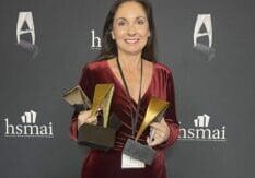 Aqua's Fran Vacarro holding an award trophy at the HSMAI award ceremonies.