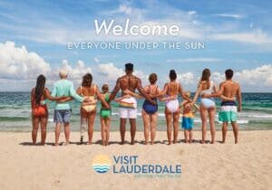 Visit Lauderale logo over a line up of people on the beach